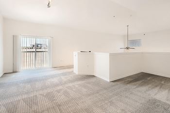 Loft room with a carpeted floor and a ceiling fan at Fox Run Lofts Apartments, Englewood CO.